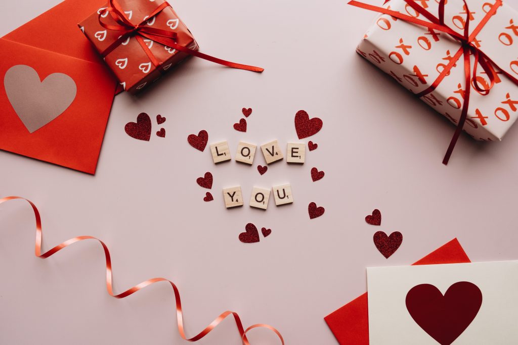CommunityAd Trades - Arts & Crafts - 'love you' text on white surface surrounded by Valentine's Day gifts and items