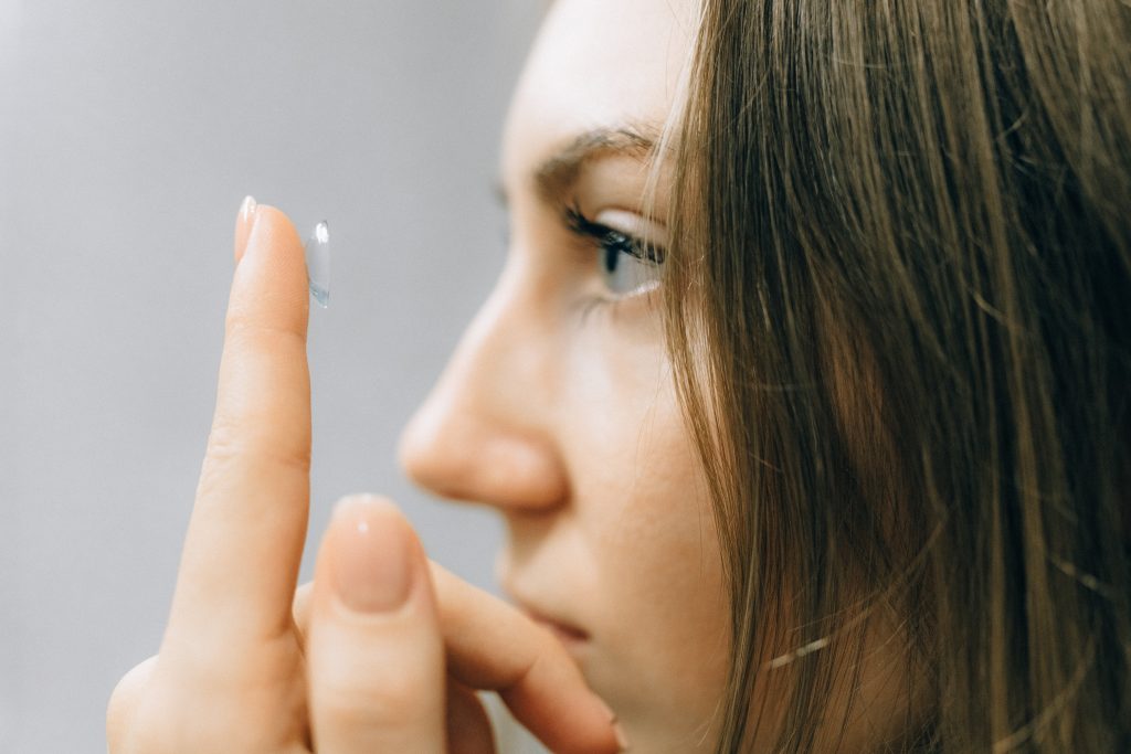 CommunityAd Trades - Opticians & Eye Health - girl putting decorative contact lenses on